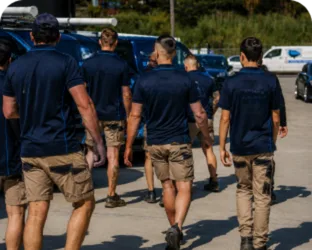 Plumbers walking to their service vans on a Gymea job